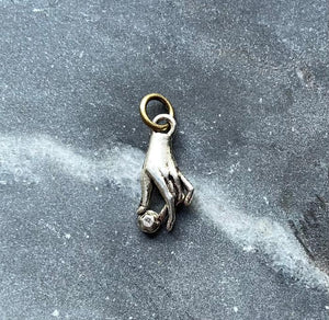 small silvery magic hand charm