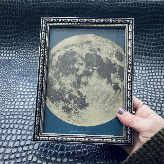 antique wooden frame with moon print.