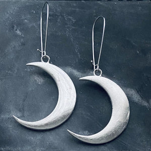 witchy silvery crescent moon statement earrings