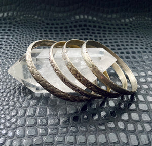 set of four vintage patterned silver toned bangles stacking bracelets