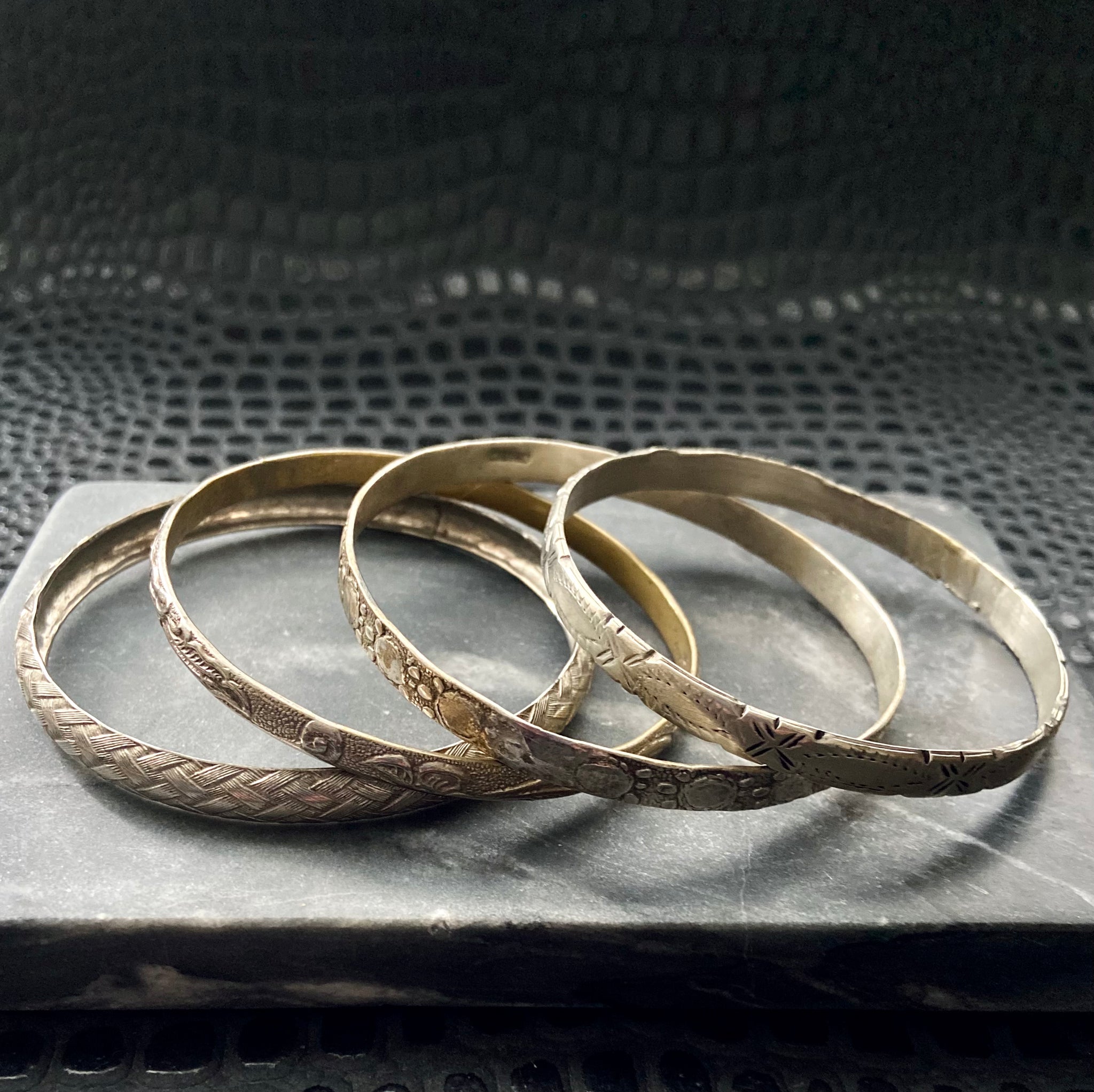 set of four vintage patterned silver toned bangles stacking bracelets